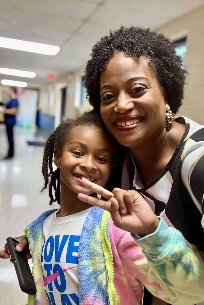 Principal and student posing for a picture
