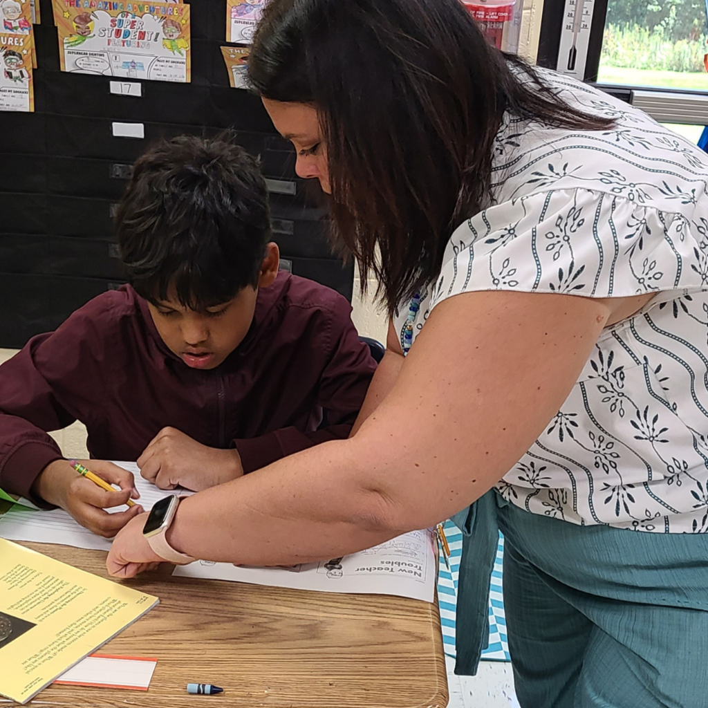 Student and teacher working on classwork