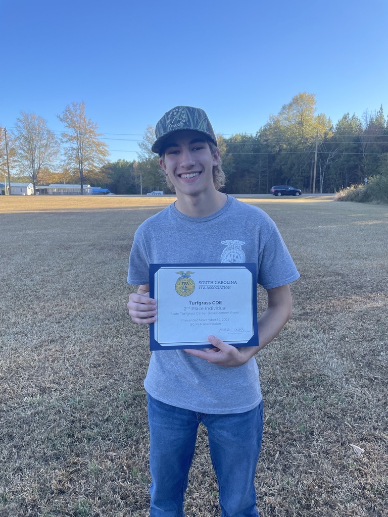 Grayson Miller holds A printed certificate from the South Carolina FFA Association for the Turfgrass Career Development Event,