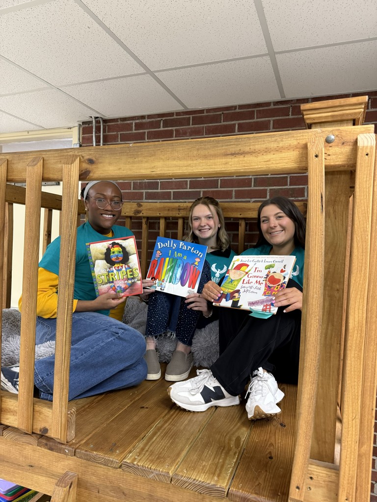 3 cadets holding books
