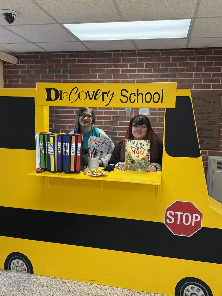 2 cadets standing by bus
