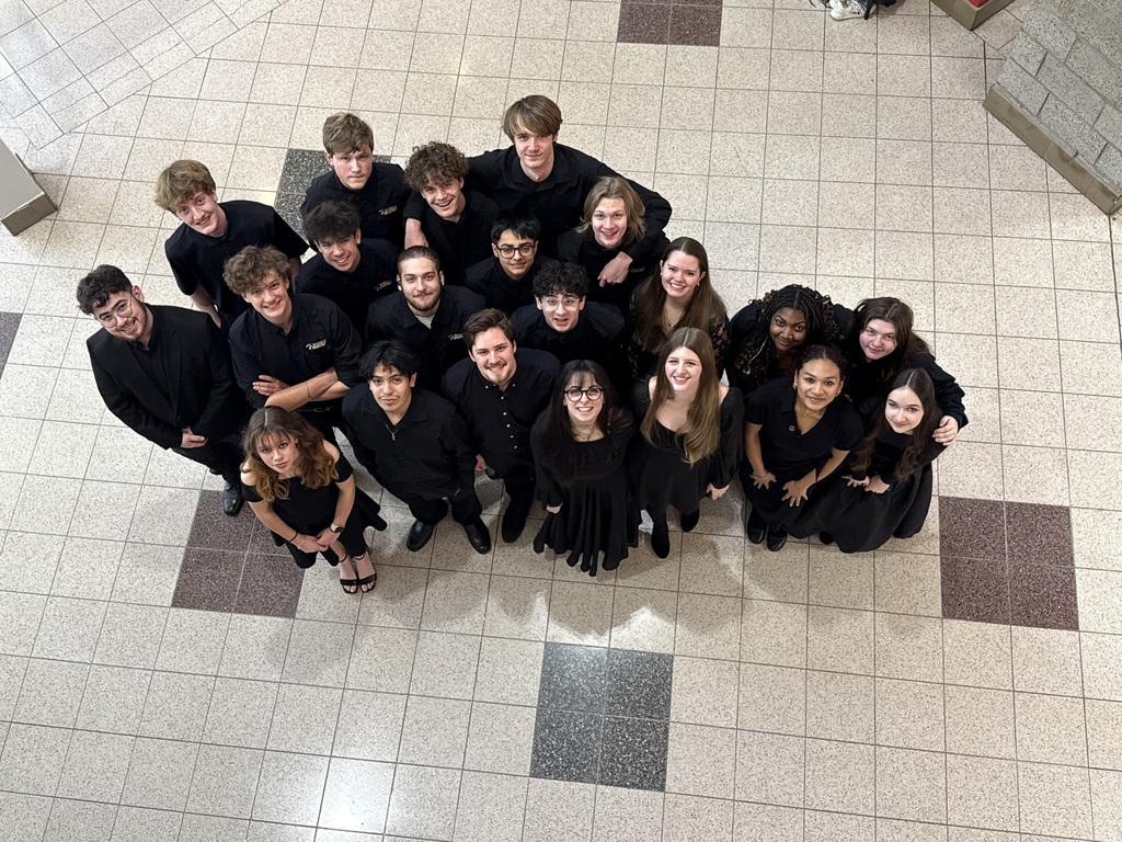 group dresses all in black prepared to preform