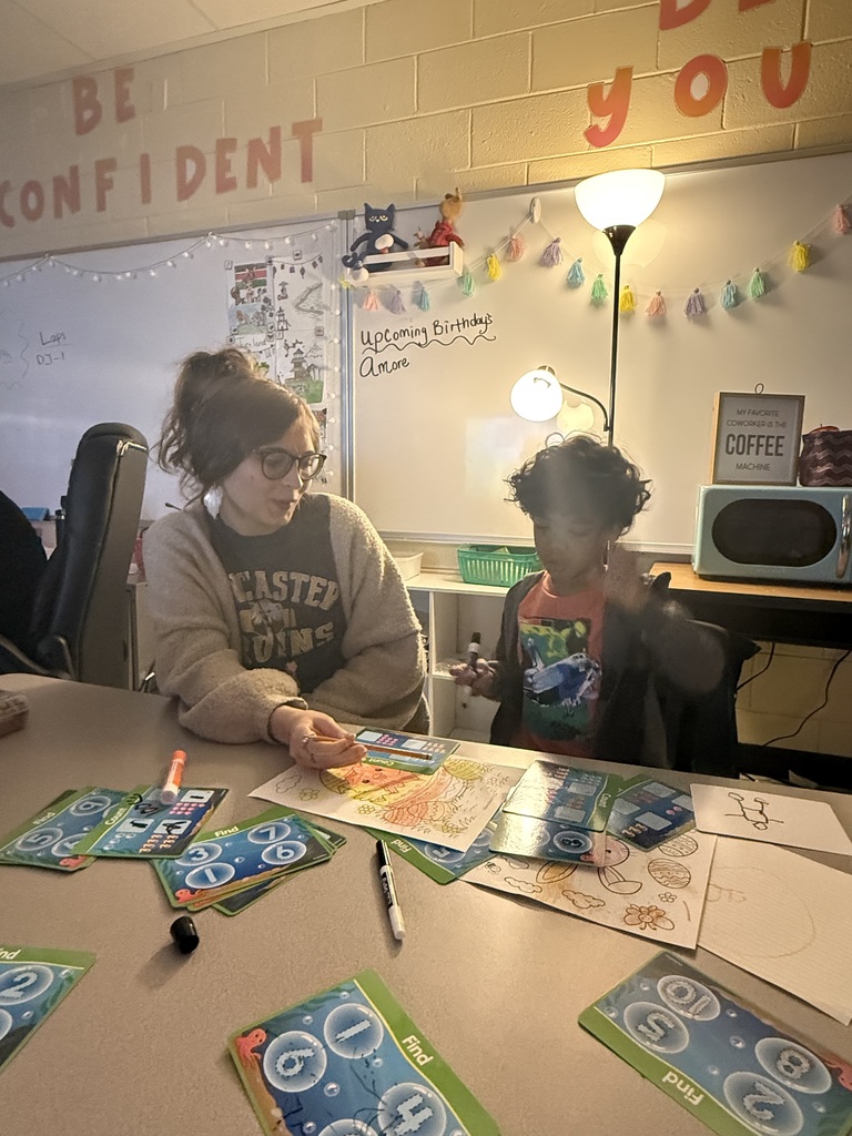 Maddi working with a student on numbers. 