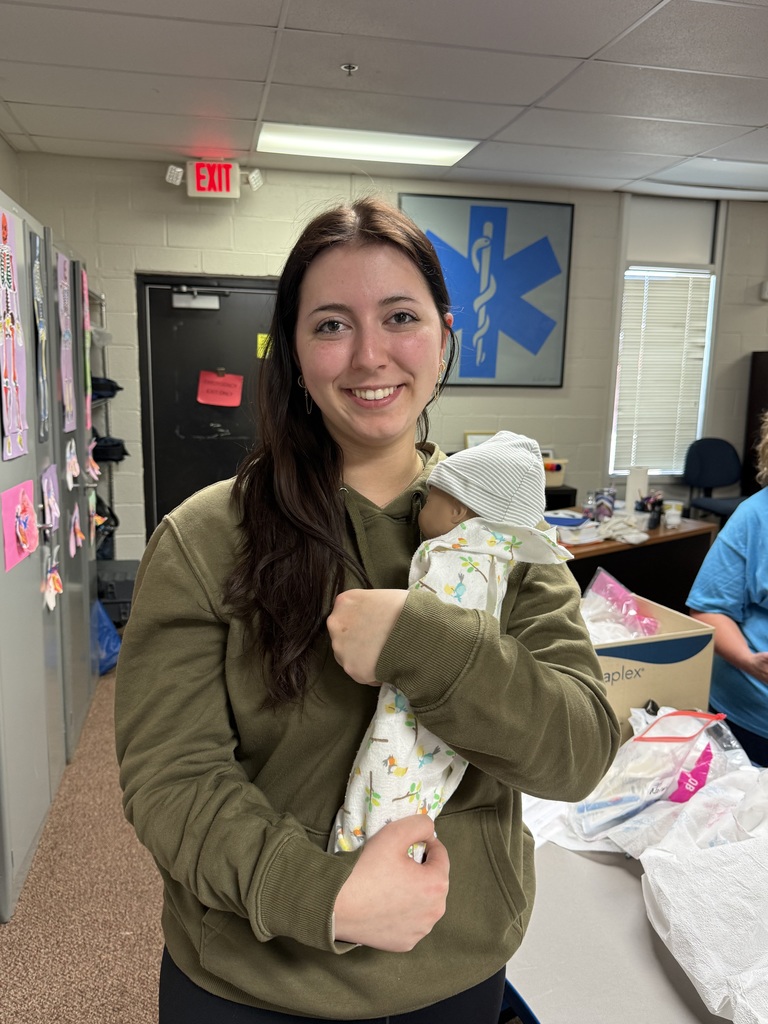 student hold newborn