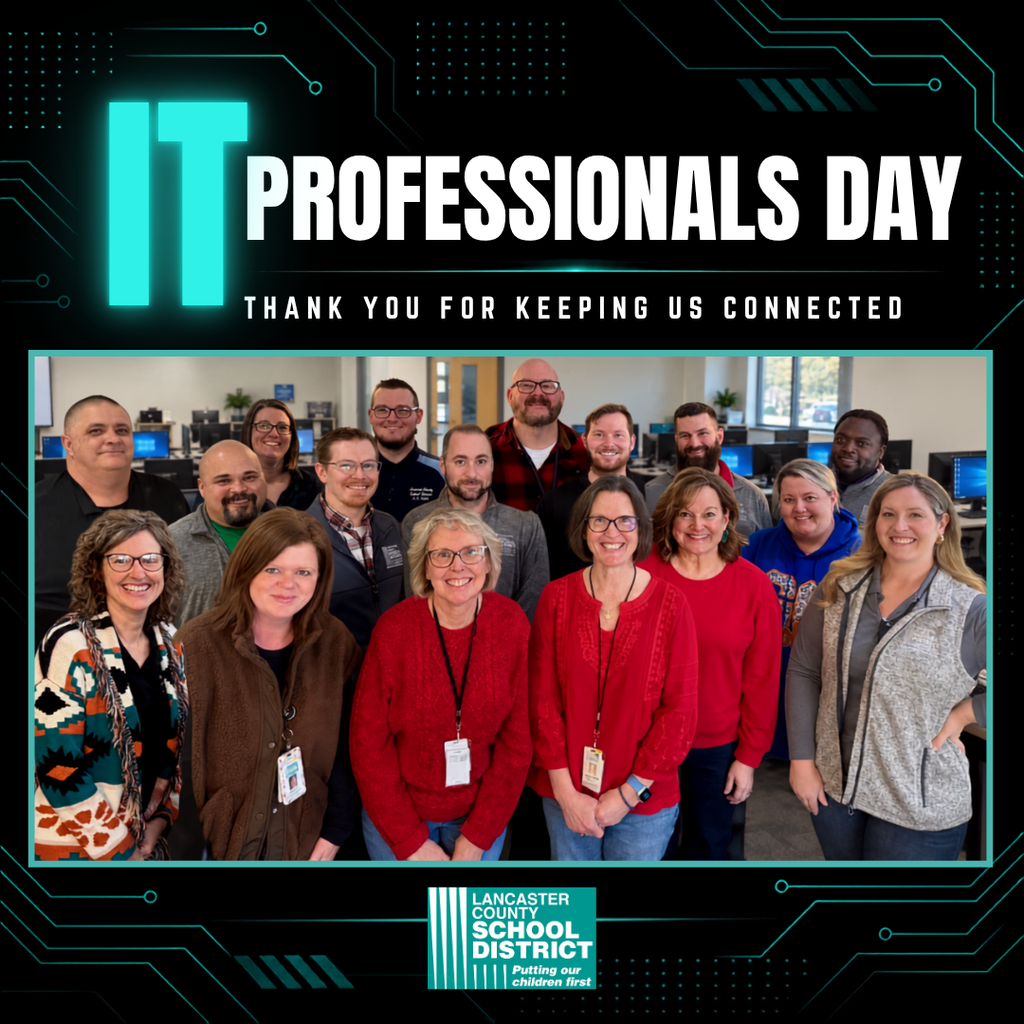 IT professionals stand together, smiling, in a room. The banner above reads "IT Professionals Day." Logo below.