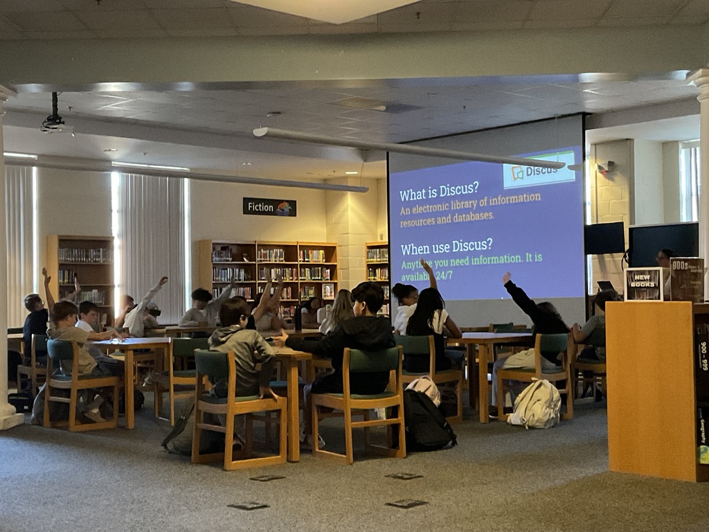 Students answer a question posed by Mrs. Moran.
