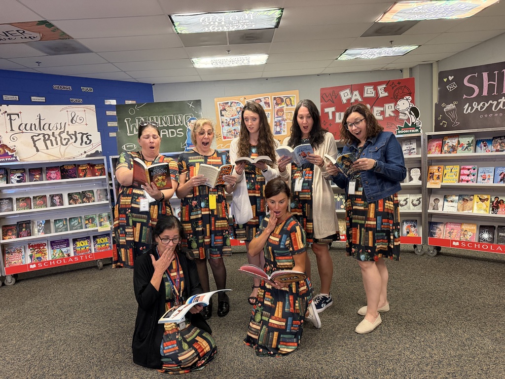 image of teachers reading books at the book fair