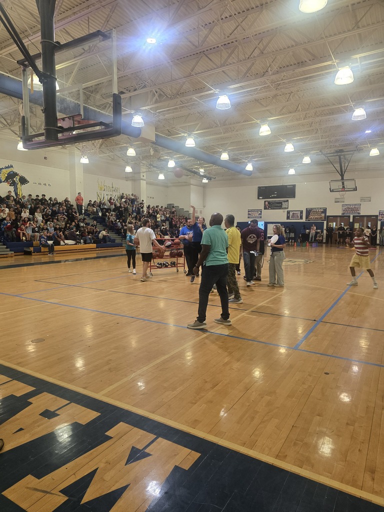 Pep Rally in gym students and teachers dancing