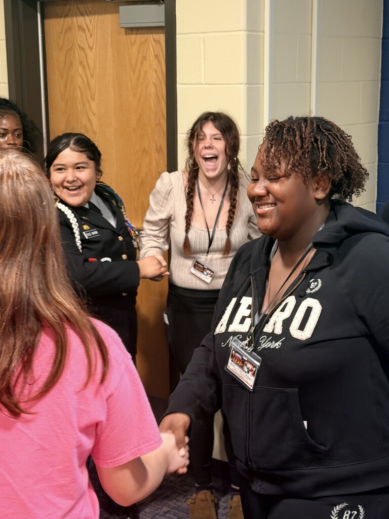 students laughing while untangling the human knot