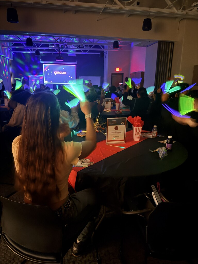 Students waving glow sticks