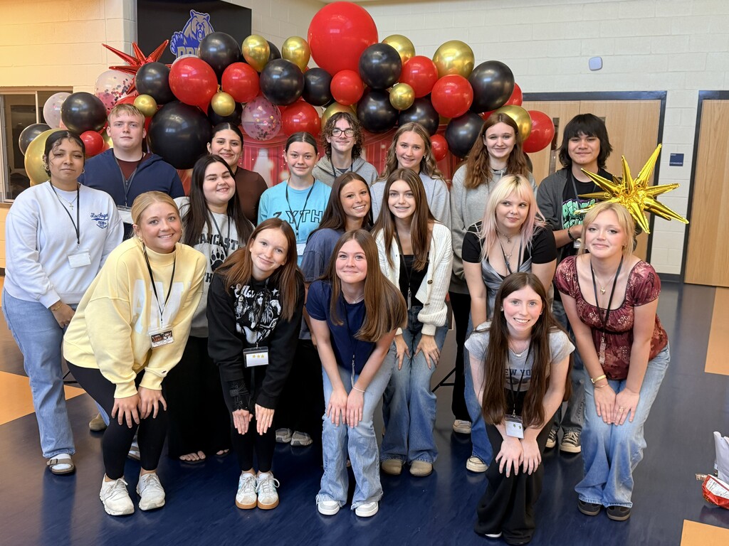 students in front of balloon arch