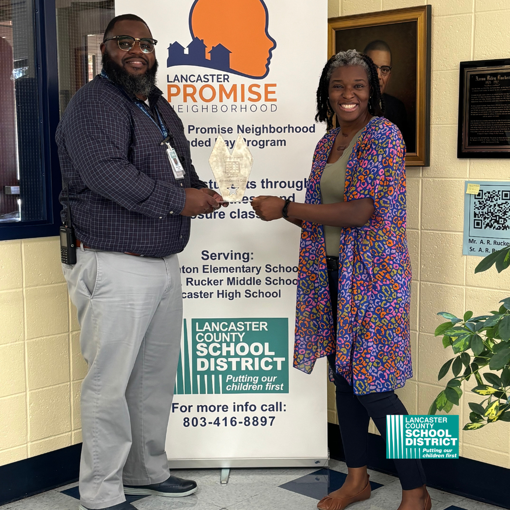 A.R. Rucker Middle School Principal (Mr. Arthur Bridges) and Attendance Clerk (Jillian Jone) holding Most Improved Attendance Percentage award