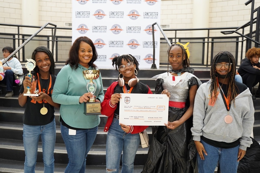 Students and Principal pose with trophies