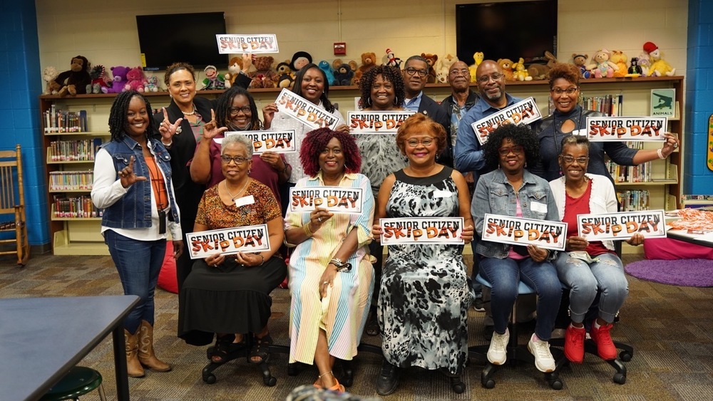 Seniors citizens pose with Lancaster ISD staff