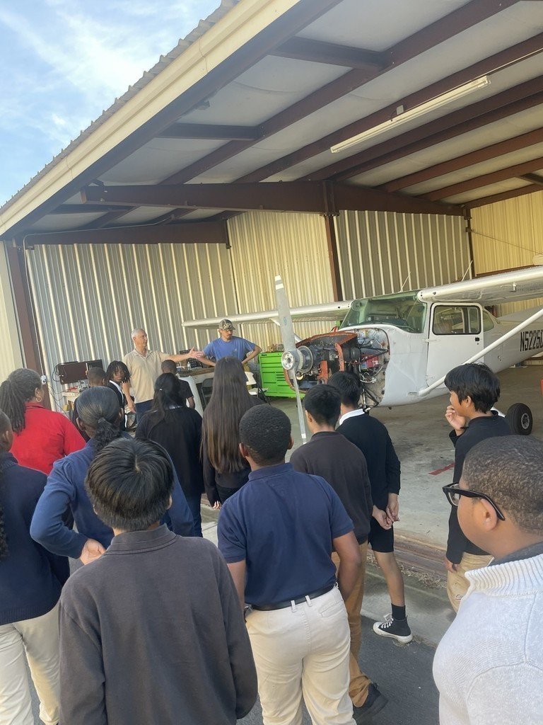 Lanett City Schools 5th and 6th grade students and teachers are at the Lanett Municipal Airport. They are shown looking closely at airplanes and various airport equipment as they learn about aviation.