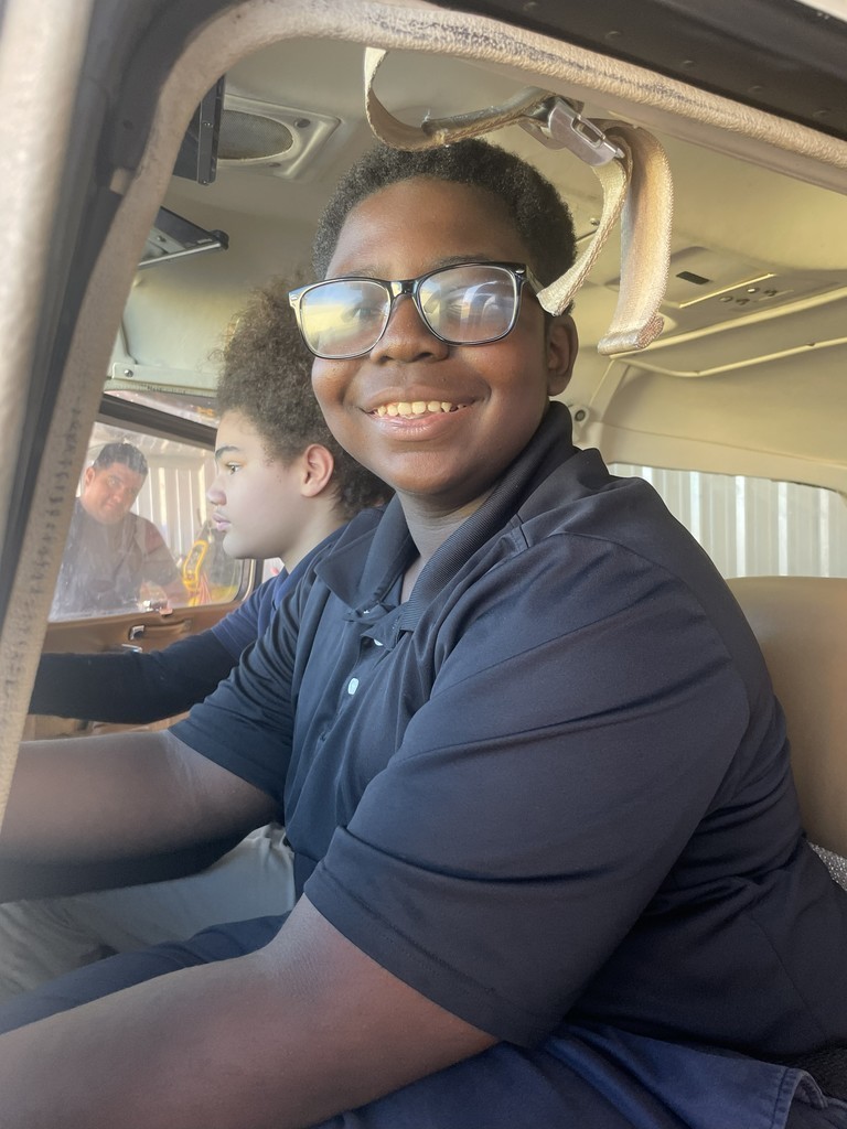 Lanett City Schools 5th and 6th grade students and teachers are at the Lanett Municipal Airport. They are shown looking closely at airplanes and various airport equipment as they learn about aviation.