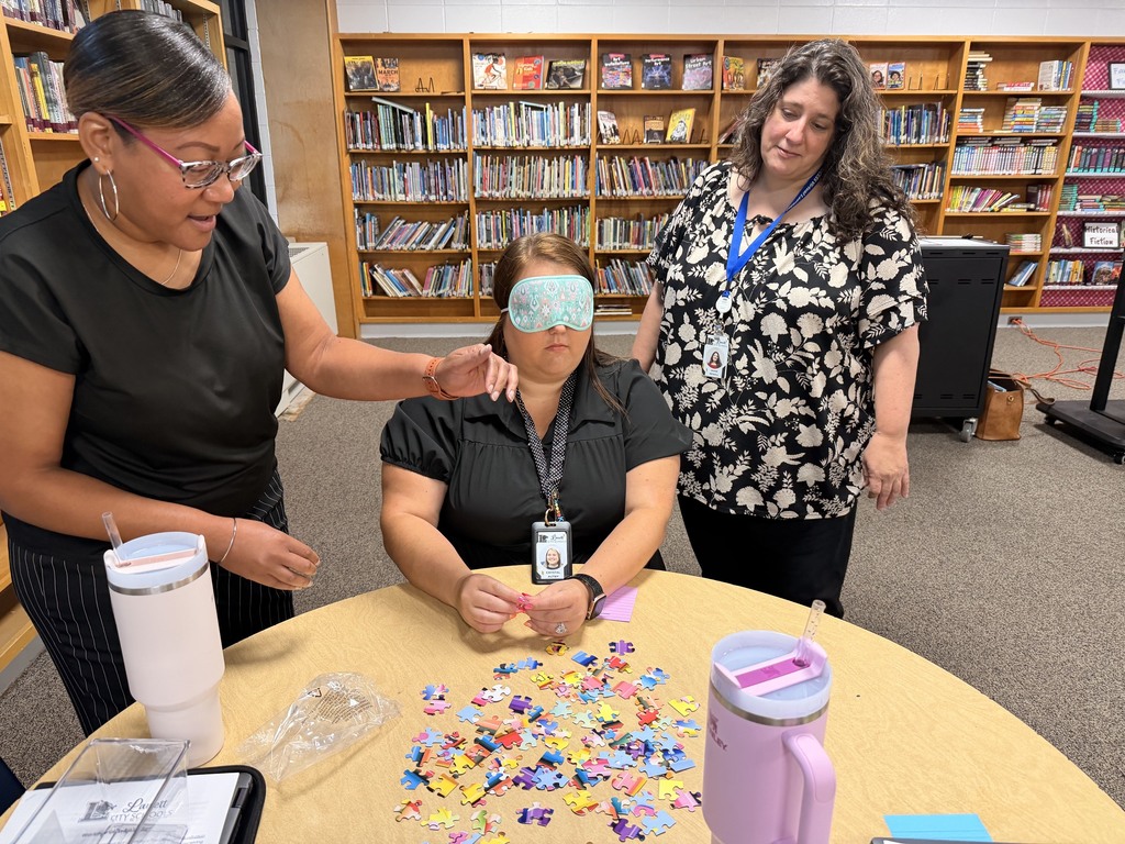 Staff working together to assemble a puzzle.