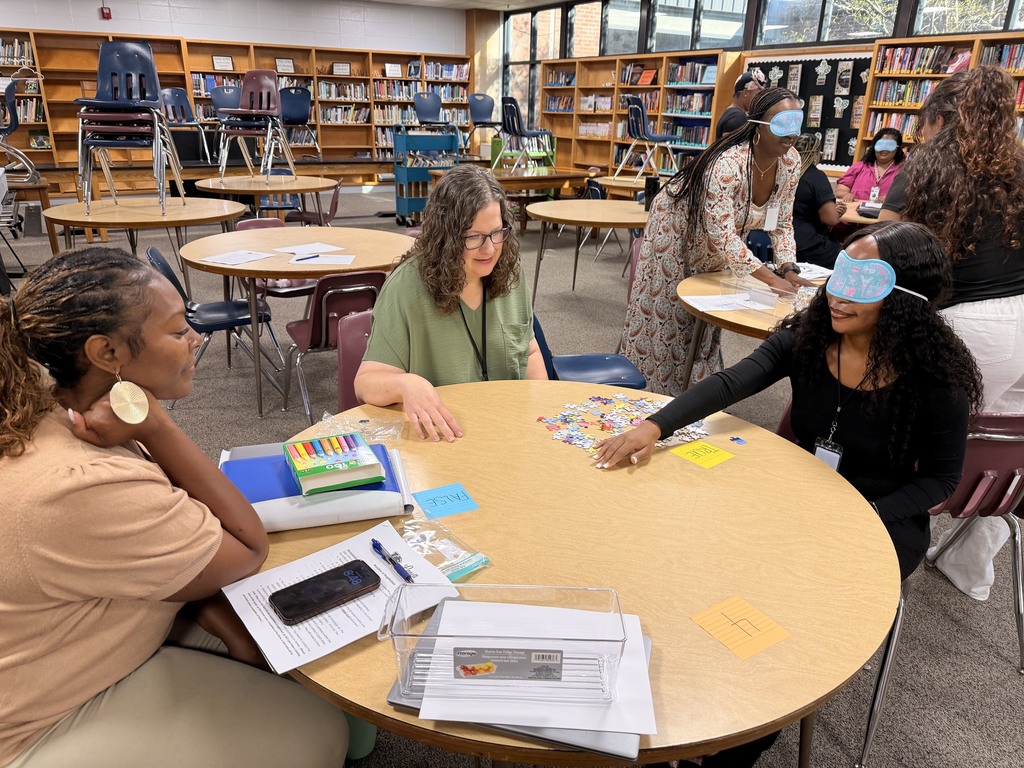 Staff working together to assemble a puzzle.