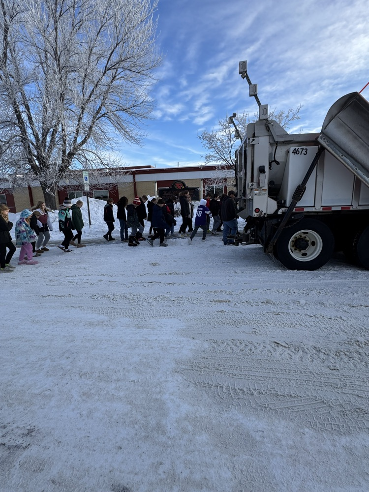 kids looking at snowplow