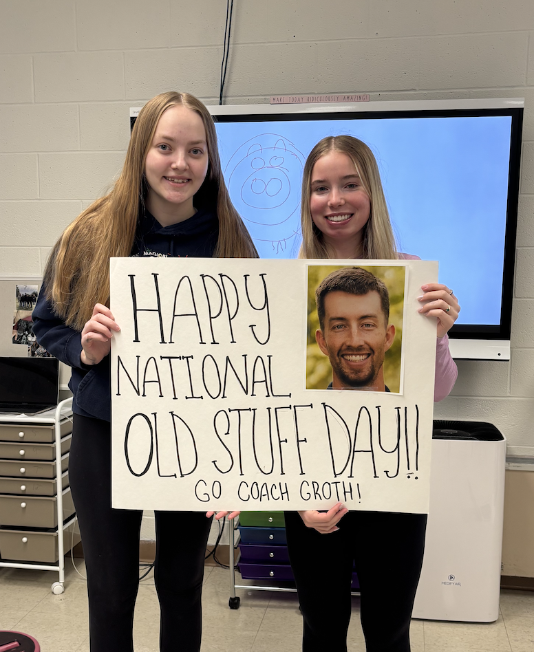 Two students with sign