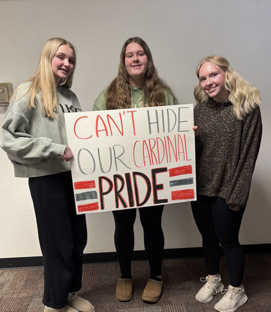three students with sign
