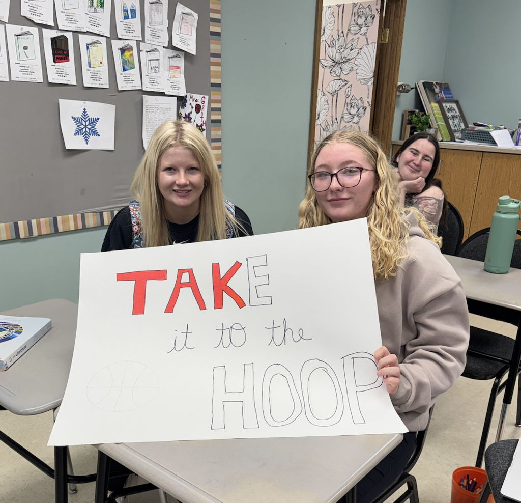 two students with sign