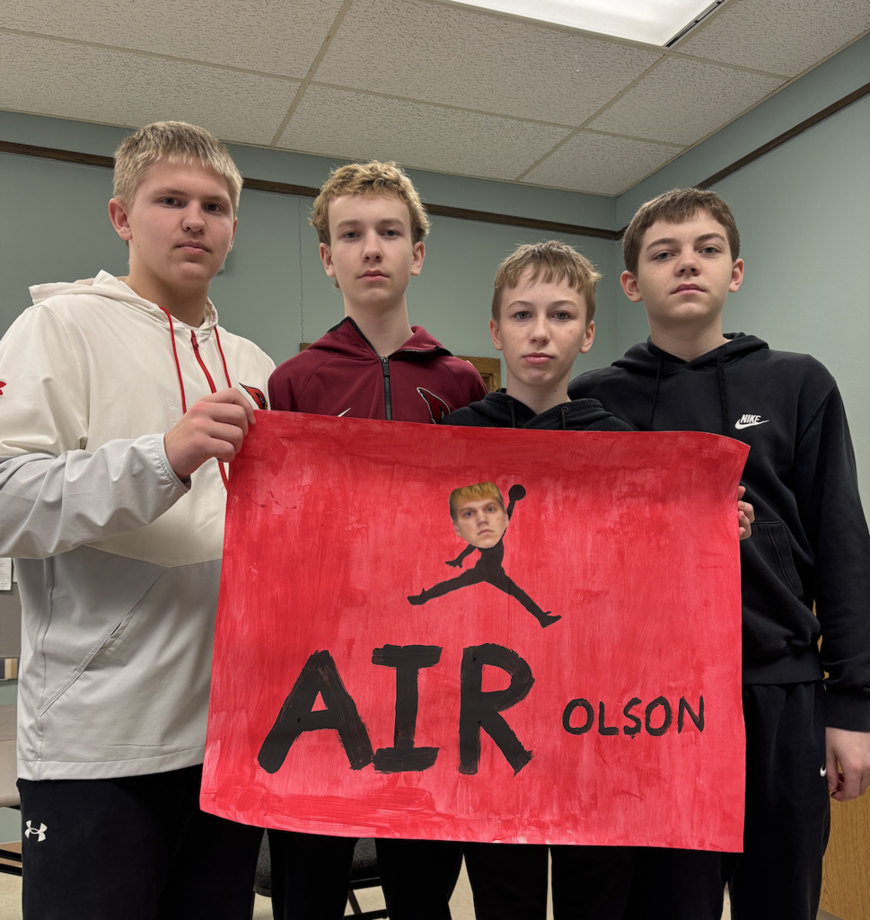 4 students with sign