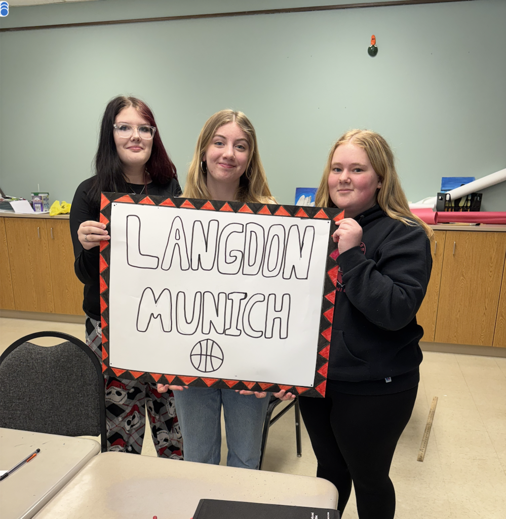 three students with sign