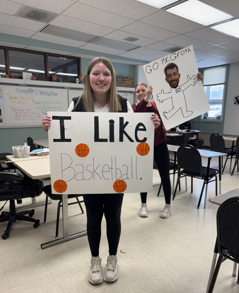 two students with two signs