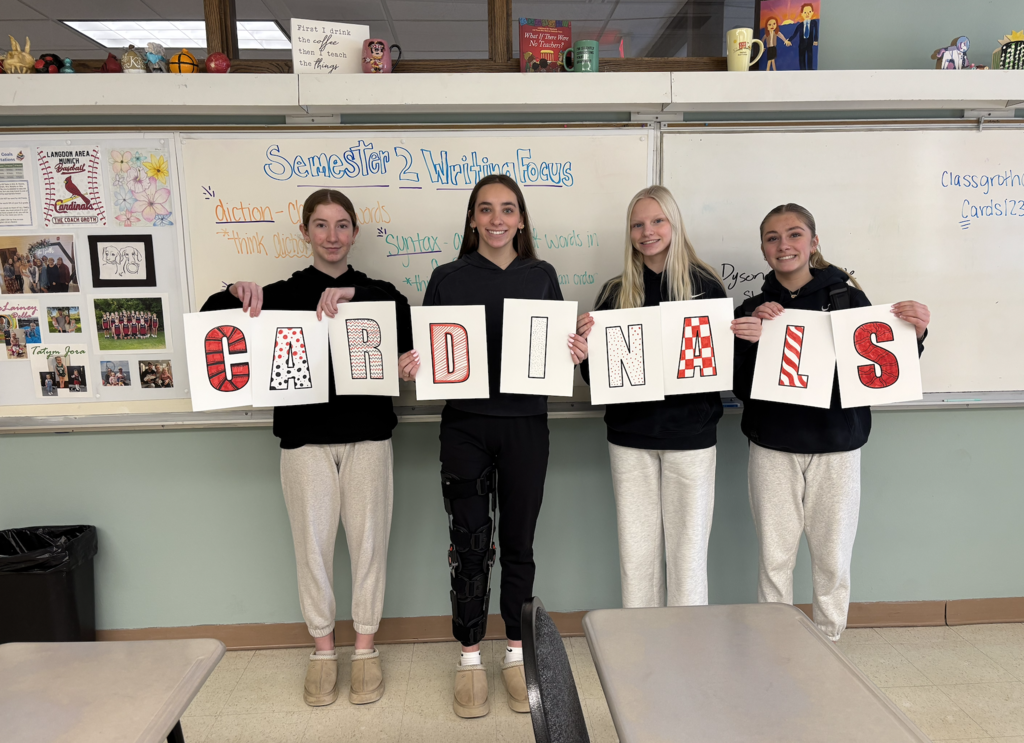 4 students holding letters for Cardinals