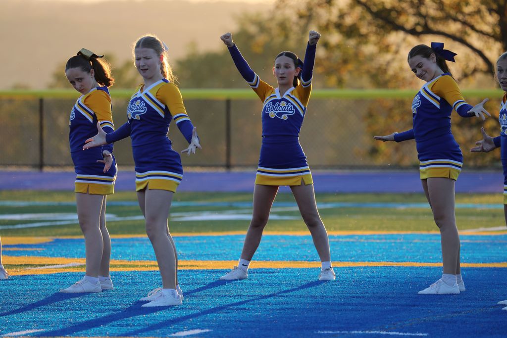 four cheerleaders mid-performance 