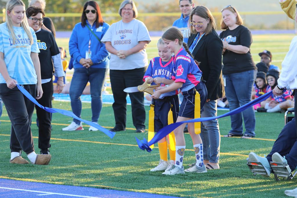 The ribbon cutting ceremony, the actual moment of cutting the ribbon by two young girls