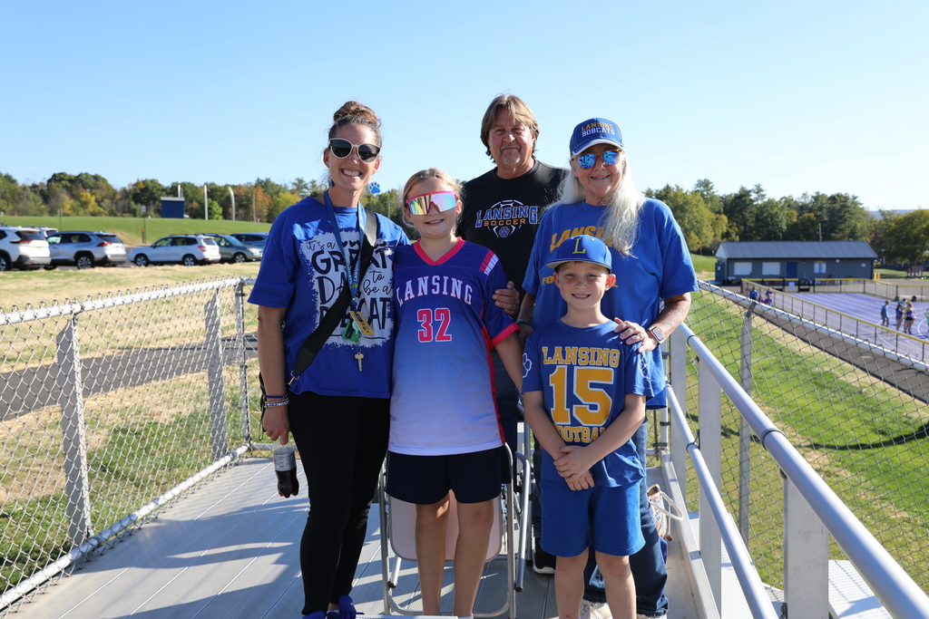 A family posing for a picture in the stands