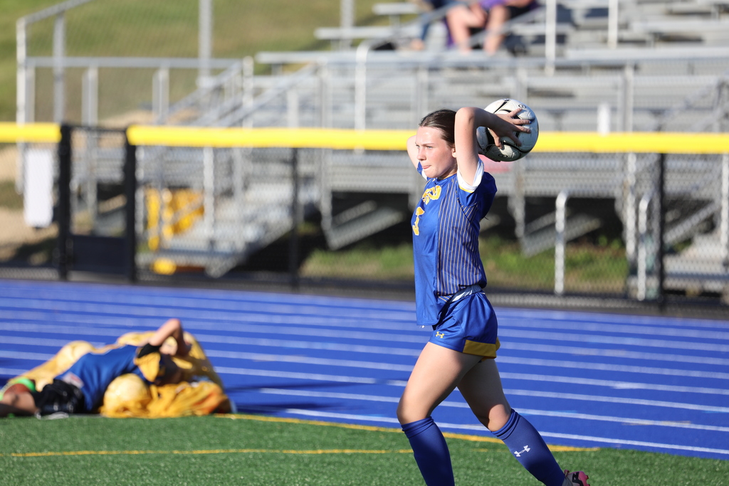 A soccer team member throwing the ball