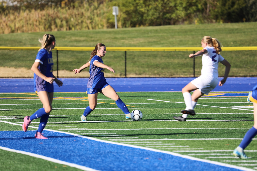 Girls soccer game in action, 3 players on field