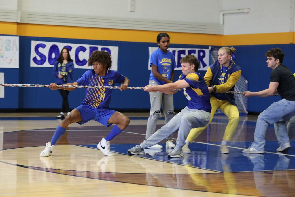 four students playing tug of war