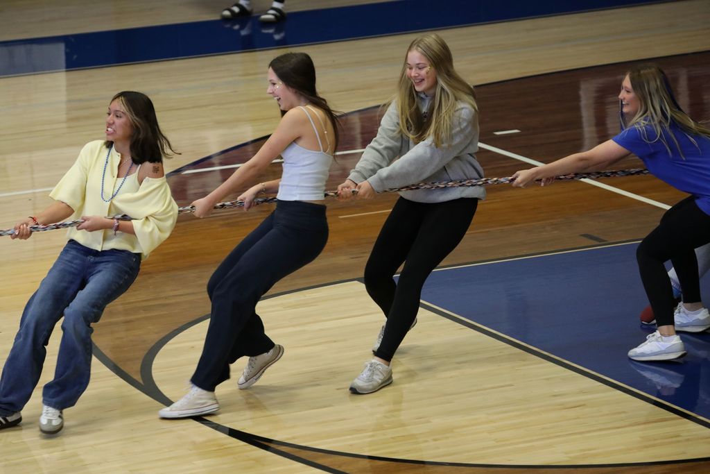 Four students playing tug of war