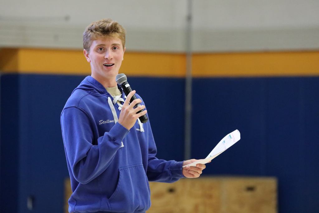 Host of the pep rally speaking into mic