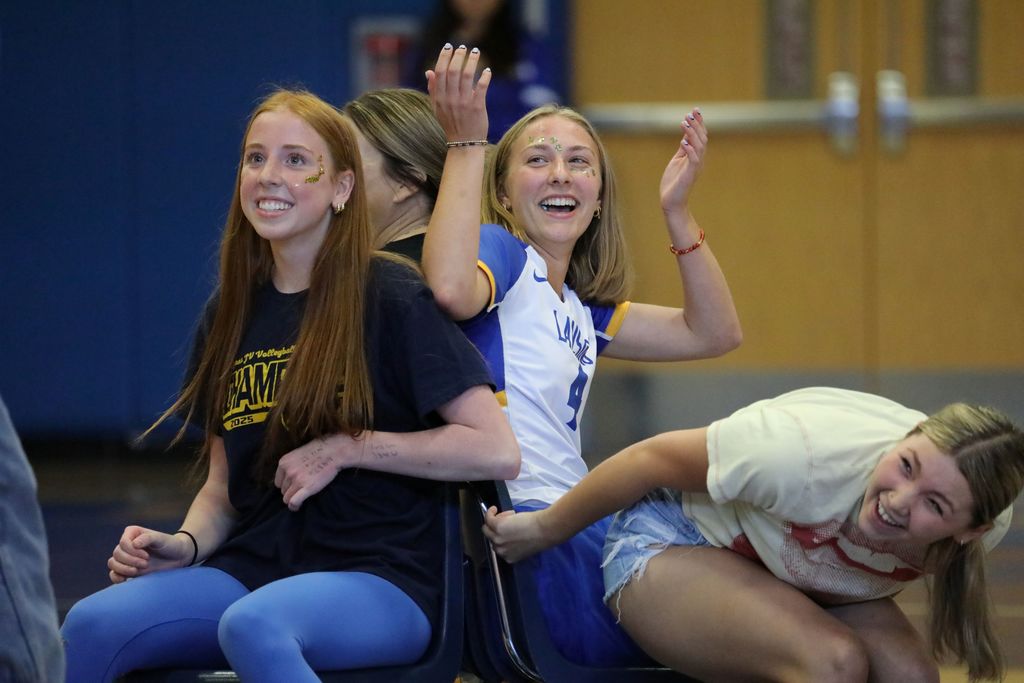 Three students reacting to musical chairs