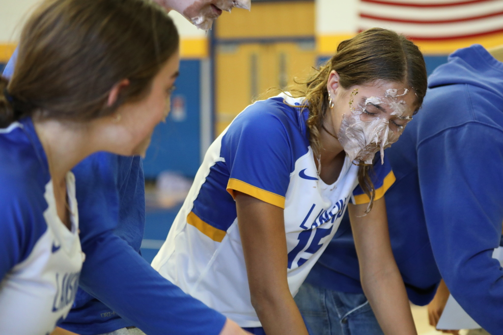 Two students with pie cream on their face from a pie eating contest