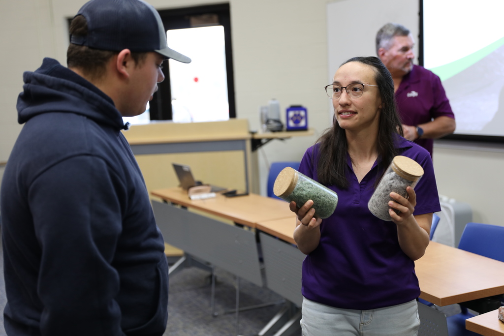 A student looking at two jars of different types of road salt
