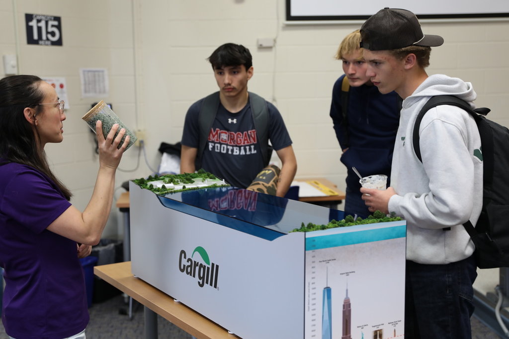 students being shown a jar of road salt from Cargill's mine