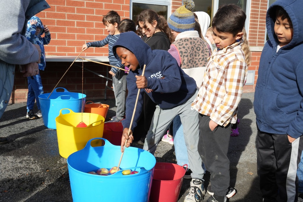 Student at fall fest doing apple fishing