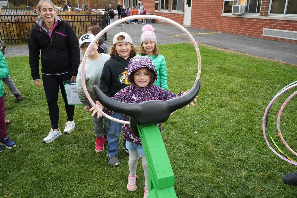 Student at fall fest lassoing with hula hoops