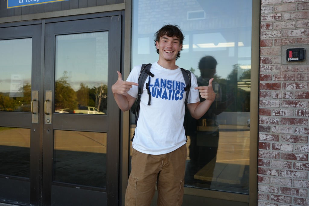 one student wearing lansing lunatics shirt and smiling from high school