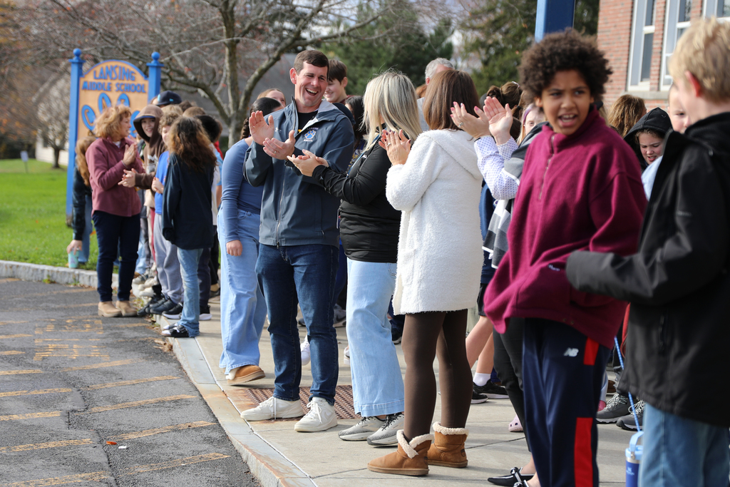 Staff laughing and clapping as they enjoy the send-off