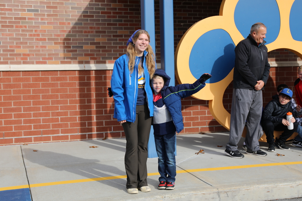 one of the student athletes posing with their brother for a photo