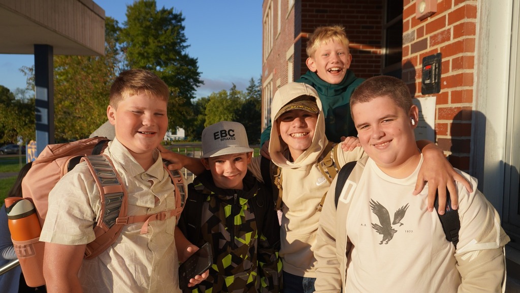 Middle school students (all boys) gathered and smiling for photo