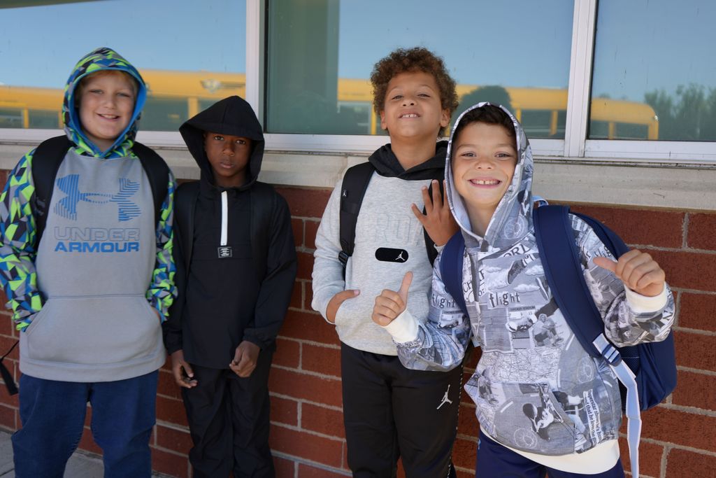 friends smiling together before entering school