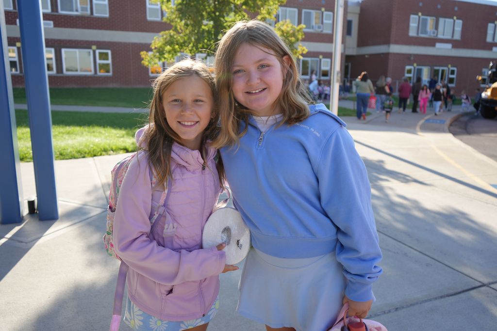 friends smiling together before entering school